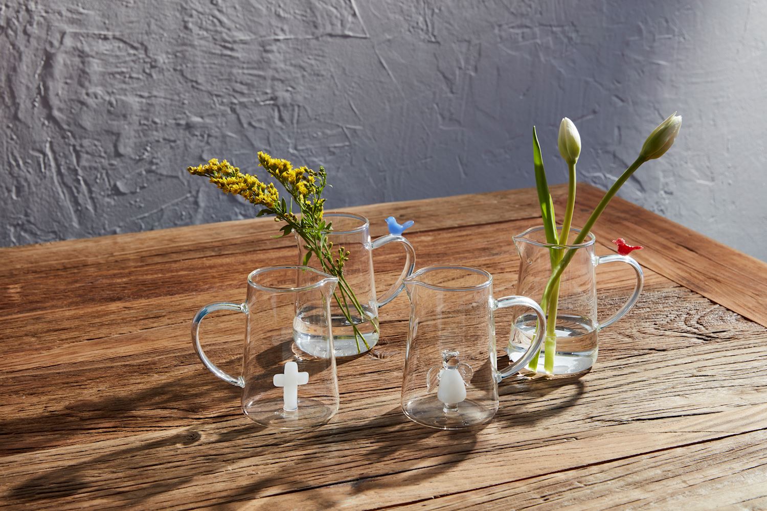 Clear glass mugs with small religious symbols, shown upright and inverted. Available in 250ml and 350ml sizes.