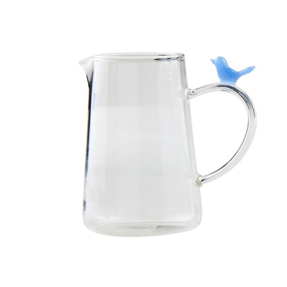 Clear pitcher-style bud vase with handle, topped by a small blue bird glass figurine. Available in small and large sizes.