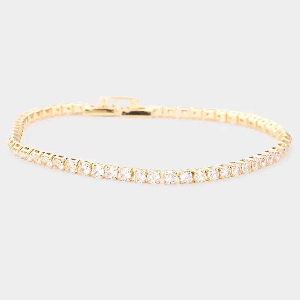 Gold Brass Metal Tennis Evening Bracelet crafted from nickel-compliant brass features sparkling white stones. Available Sizes: Adjustable (one size fits most).