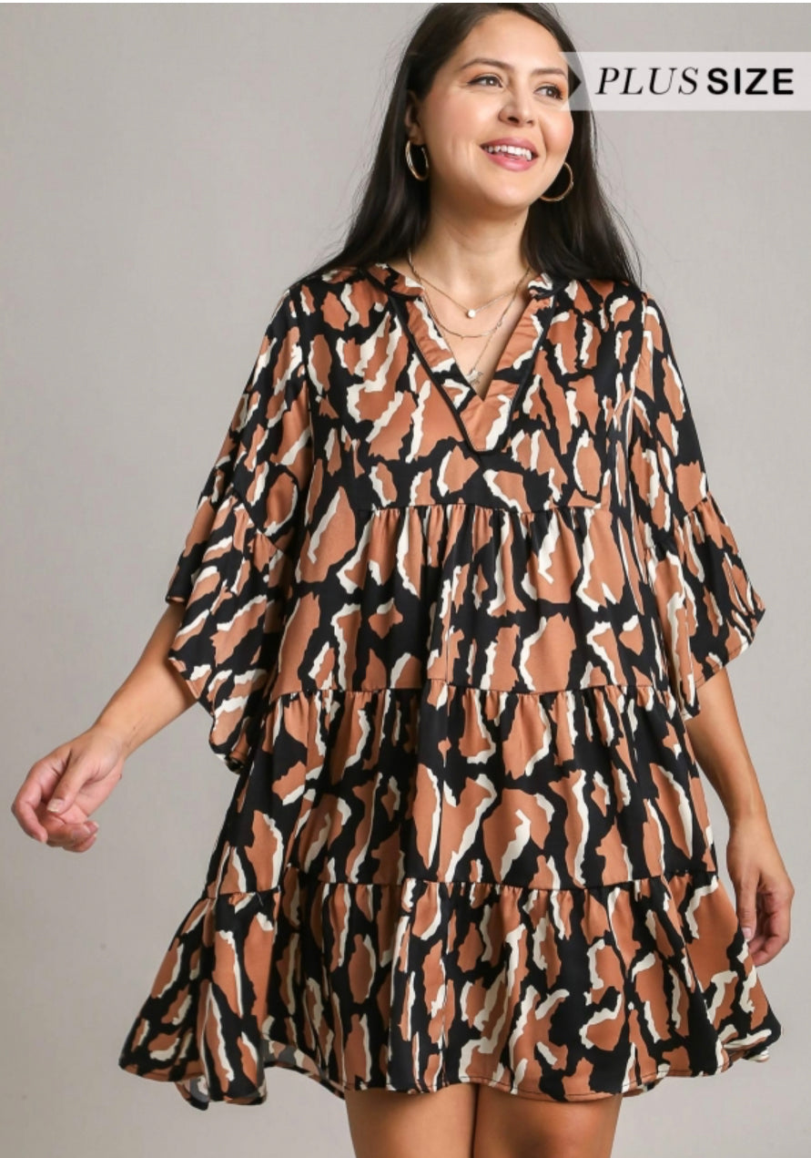 This product is a V-Notched Animal Print Tiered Dress. Offered in plus size, this dress features an attractive animal print pattern and stylish tiered design. The piece also boasts a V-notched neckline for added charm. No other products are included with this item.