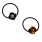 Two Camellia Hair Ties: one with a black rose-shaped accessory featuring a spiral center, and the other with a tortoiseshell-patterned rose showcasing a spiral center. Crafted from glossy material, attached to durable brown elastic bands. Available in one size.