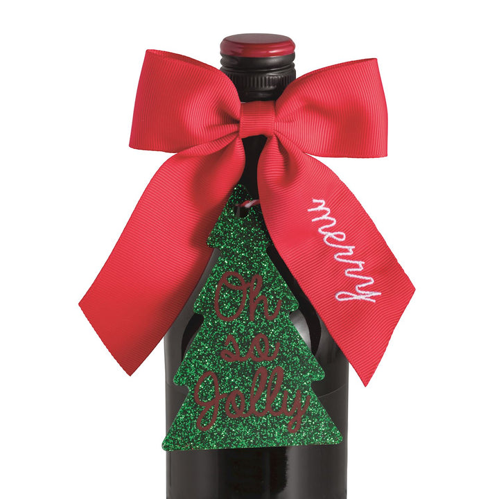 Bow Topper &amp; Gift Tag Set featuring a red bow and a glittery green Christmas tree gift tag inscribed with “Oh so jolly.”.