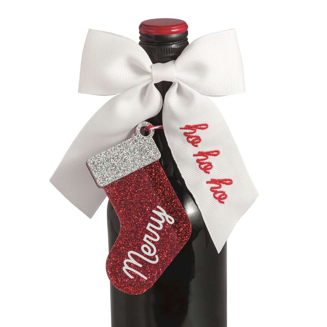 Bow Topper &amp; Gift Tag Set featuring a white bow and a red glittery stocking gift tag labeled Merry and ho ho ho.