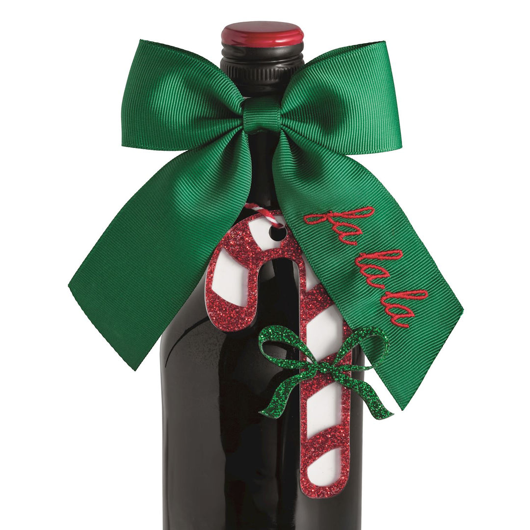 Bow Topper &amp; Gift Tag Set featuring a green ribbon bow with “fa la la” embroidery and a glittery red and white candy cane gift tag.