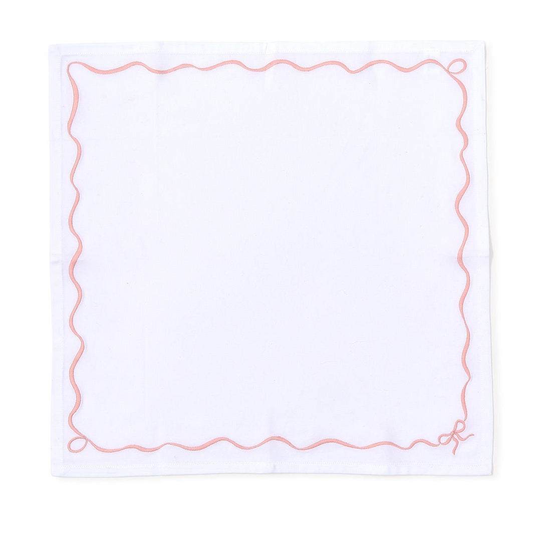 Set of 4 white cotton napkins with pink wavy border and small embroidered bow; available in 20" x 20" size.
