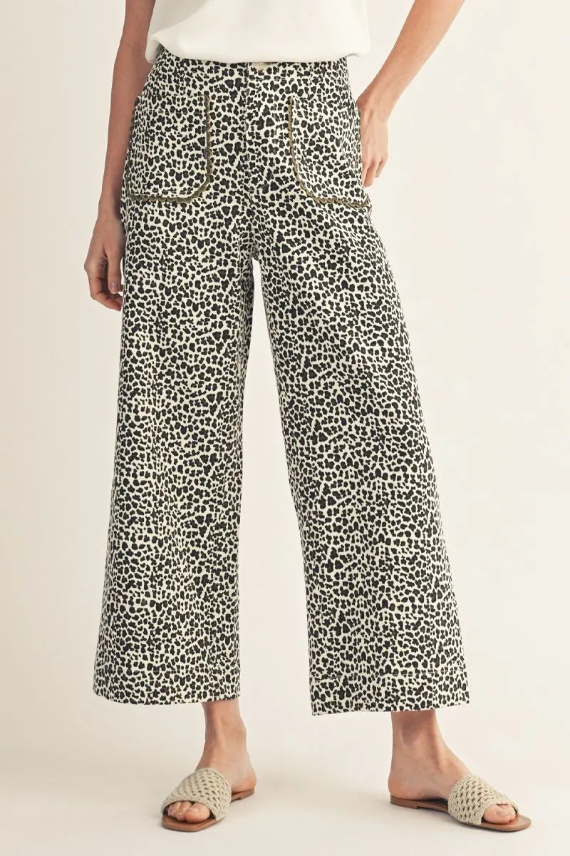 Ivory Scallop Trim Animal Print high-waisted wide-leg jeans with black-and-white print, scallop pockets, and green detailing.