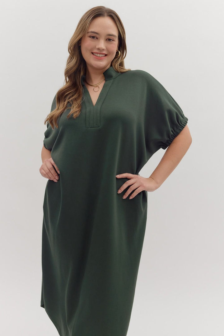 Forest green Collie Midi Dress with V-neck, band collar, lightweight knit, and gathered short sleeves. Available in all sizes.