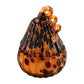 Small orange pumpkin-shaped candle with black spots and curly stem. Available sizes: small.