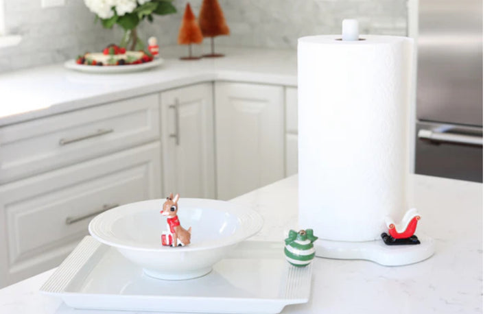 Nora Fleming Pinstripe Melamine Bowl and Plate Set. Sizes available: Standard. Features festive scene with reindeer figurine and Christmas tree figurine.

Paper Towel Holder Pinstripes, adorned with a green ornament and red sleigh.