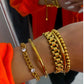 Gold bracelet set: Includes a chain bracelet with crystals, sleek bangle, Thick Gold Watchband Bracelet, and beaded bracelets. Available in sizes XS-L.