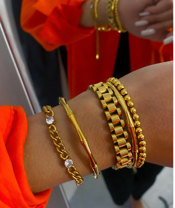 Gold bracelet set: Includes a chain bracelet with crystals, sleek bangle, Thick Gold Watchband Bracelet, and beaded bracelets. Available in sizes XS-L.