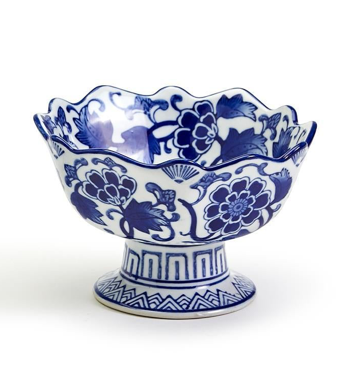 Hand-painted blue and white porcelain scalloped edge footed bowl with floral patterns.