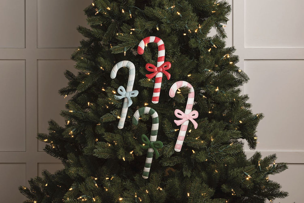 Four tin candy cane ornaments with bows.