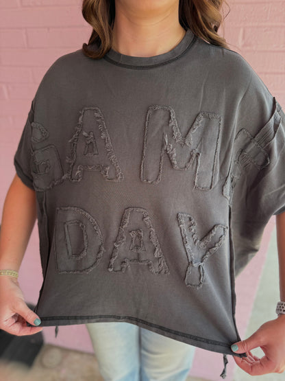 Gray Dye & Wash Gameday Terry Top with rough-edged “GAME DAY” lettering in soft French terry; relaxed fit; available in sizes XS-XL.