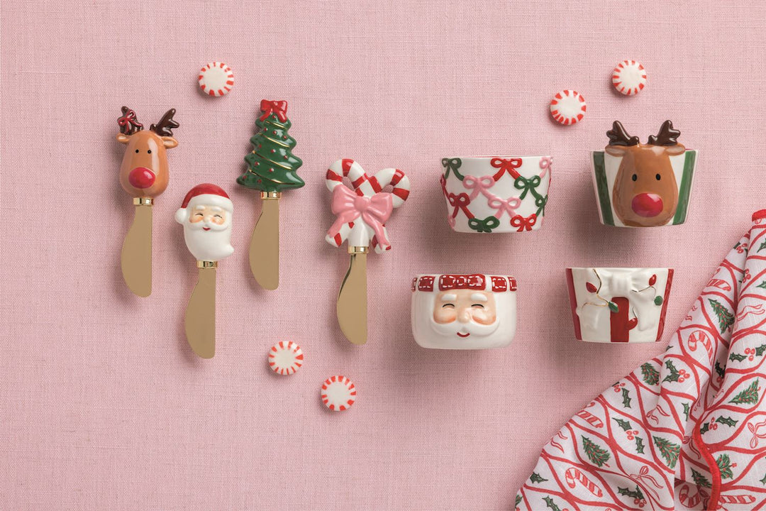 Four Christmas Whimsy Spreaders with reindeer, Santa, tree, and candy cane handles.