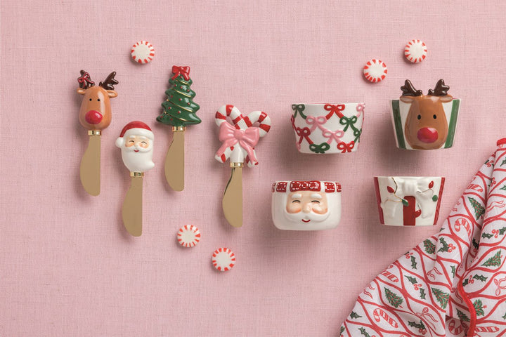 Four Christmas Whimsy Spreaders with reindeer, Santa, tree, and candy cane handles.