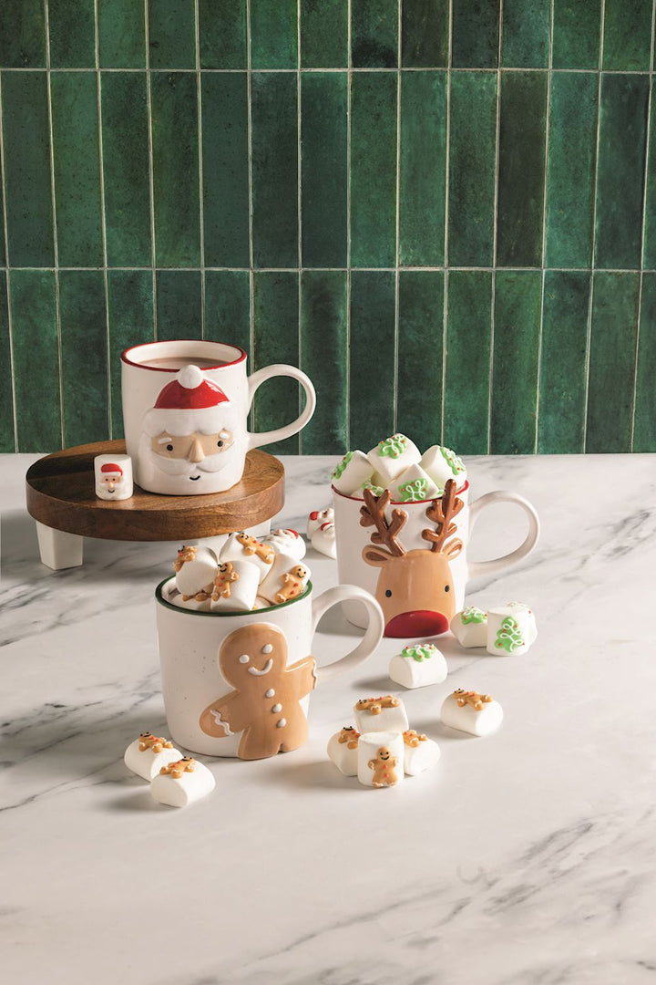 Santa, reindeer, and gingerbread man stoneware holiday mugs.