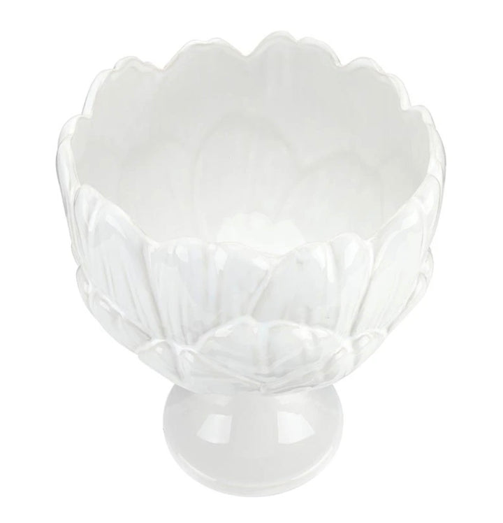 White ceramic bowl with scalloped, petal-inspired edges and a short pedestal base; glossy finish. Sizes available: small, medium, large.