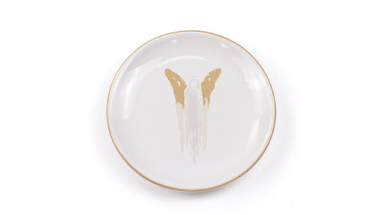 This Angel Trinket Dish is a minimalist white ceramic piece with brown wing-like shapes and a central column. It's ideal for stashing small treasures, keys, or jewelry. The dish features clean lines and a simple design on a plain white background. The product is only available in one size.