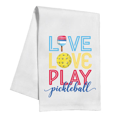 White cotton, machine washable kitchen towel; "Love Love Play Pickleball" in colors with paddle and yellow pickleball as O's. Sizes: N/A.