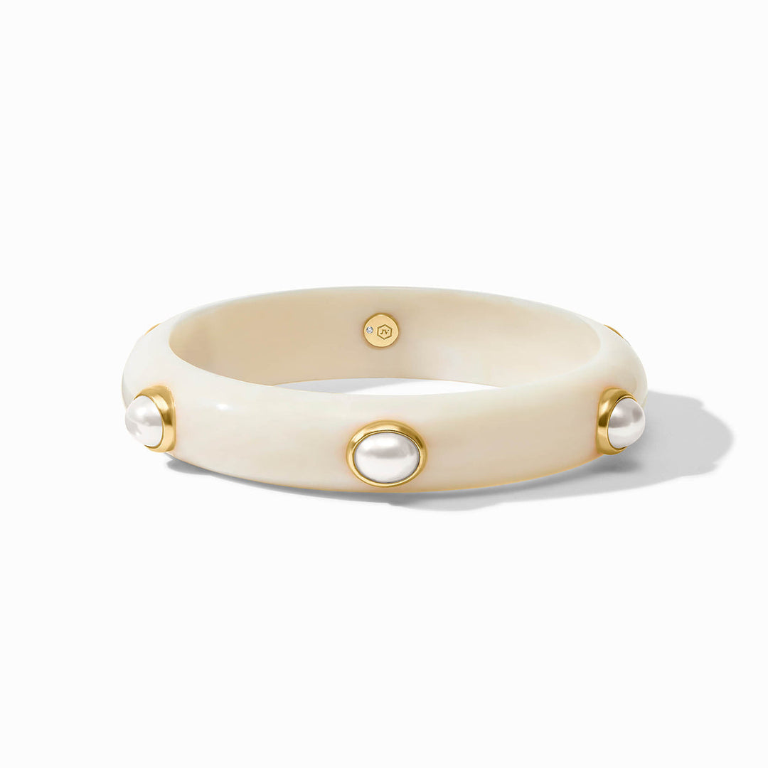 Cream bangle with evenly spaced pearl-like accents in gold bezels. Available in multiple sizes.