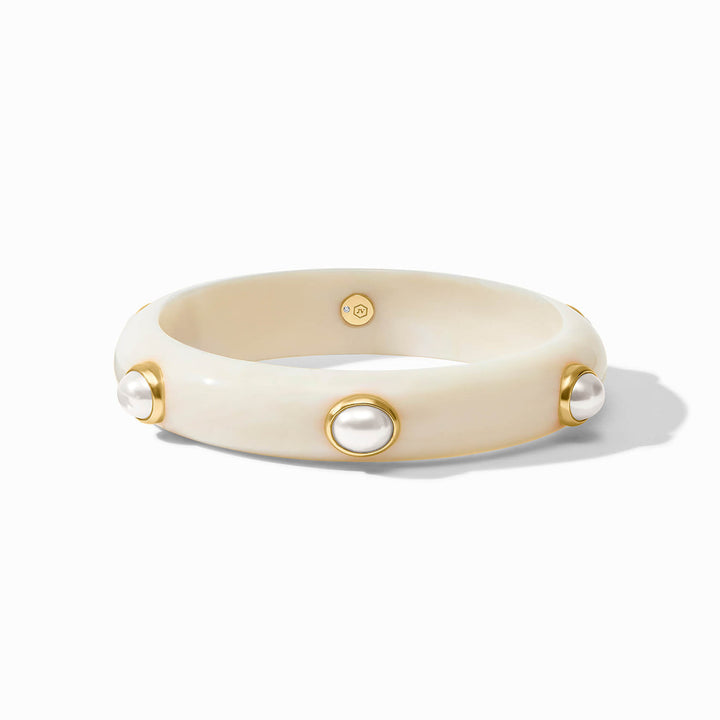 Cream bangle with evenly spaced pearl-like accents in gold bezels. Available in multiple sizes.