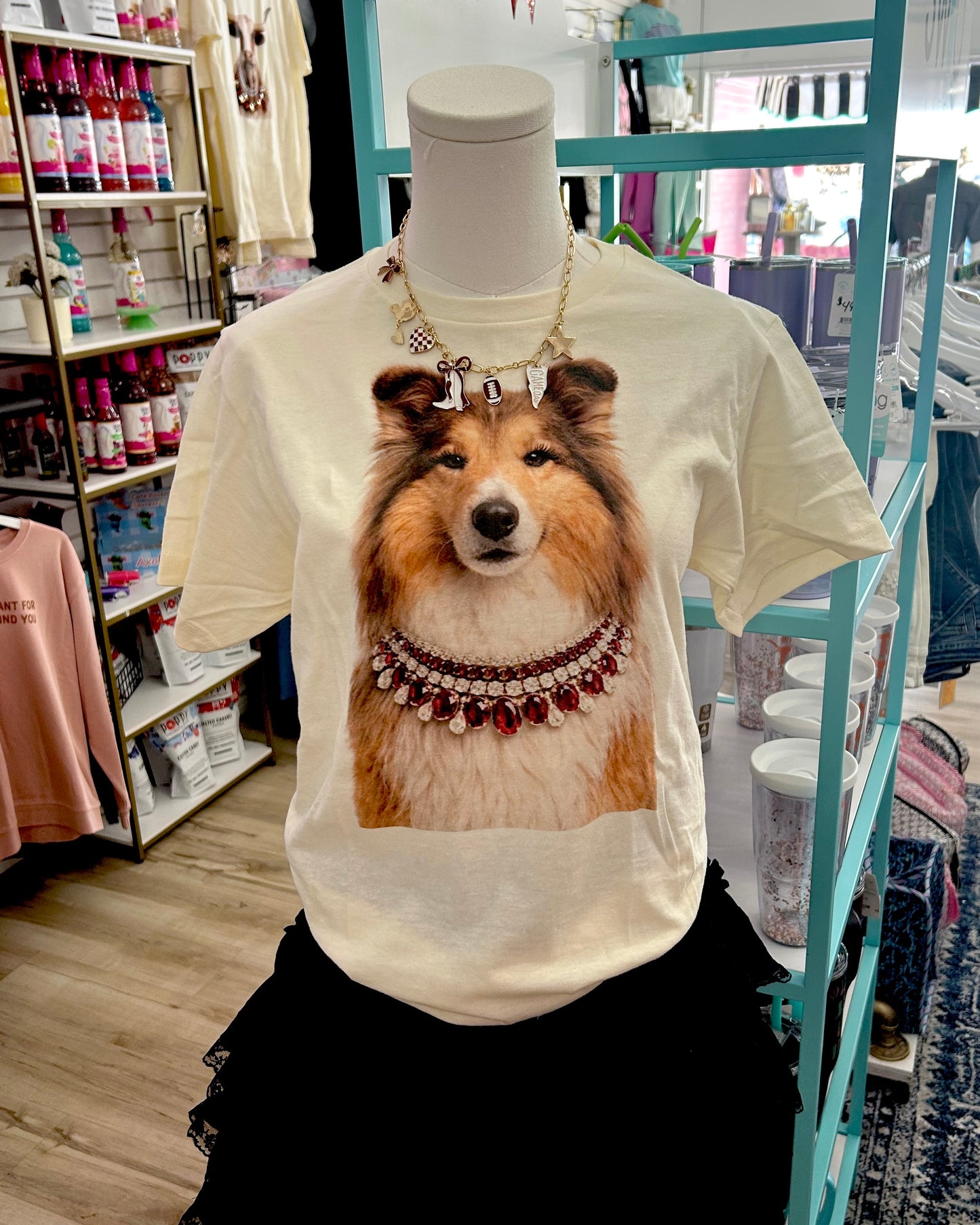White unisex t-shirt featuring a large print of a collie dog wearing a jeweled necklace. Available in sizes S-XXL.