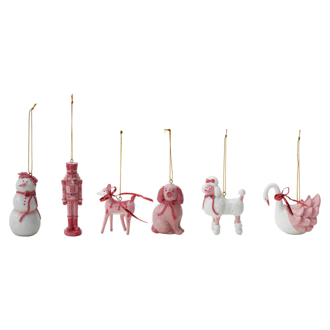 Festive Resin Christmas Ornaments: six glittery pink and white polyresin decorations featuring a snowman, nutcracker, deer, dog, poodle, and swan.
