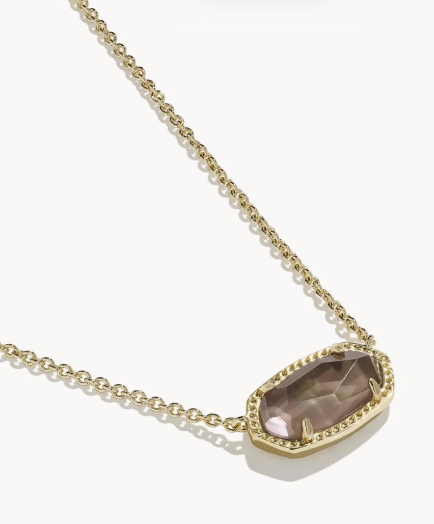 Gold chain necklace with an oval faceted taupe gemstone pendant set in a gold bezel with delicate edge detailing. Available in one size: 15″ chain with 2″ extender.