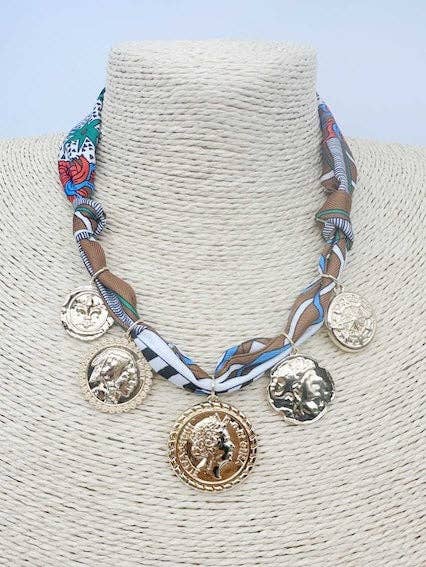 The Ansley Brown Necklace: multicolored fabric band, five gold coin pendants with unique faces, adjustable, available in one size.