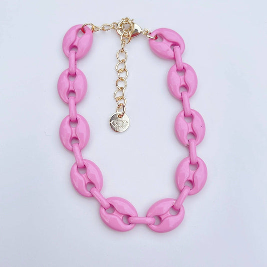 The Pink Link Bracelet has chunky pink oval links, gold adjustable clasp, heart charm. Available in S, M, and L sizes.