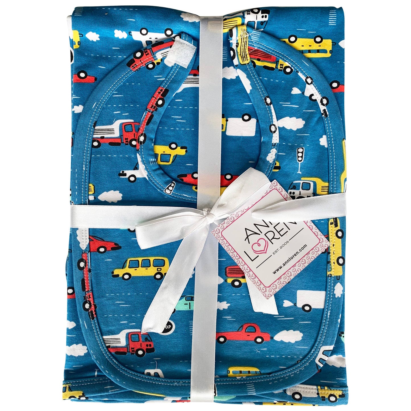 Blue cars and trucks patterned set tied together with a white bow and "Ann Loren" tag.