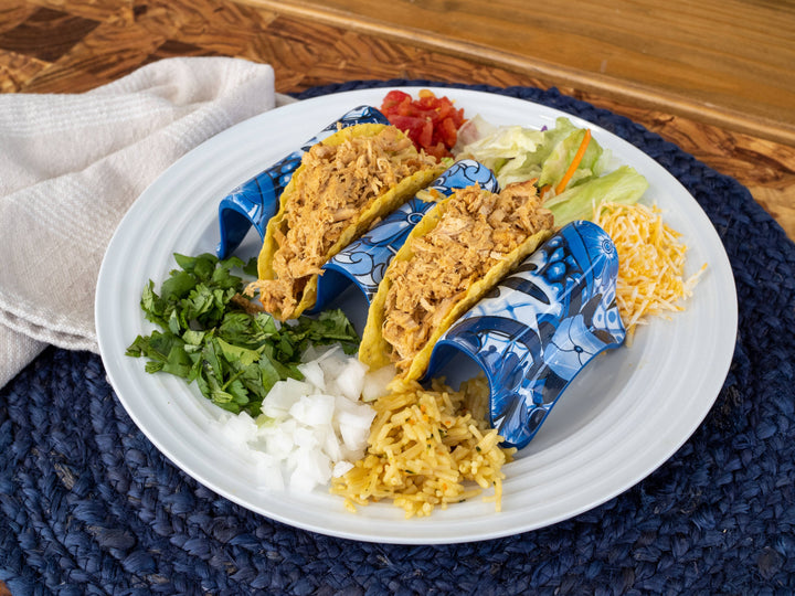 Two hard shell tacos with shredded chicken, cilantro, onions, cheese, lettuce, tomatoes. Size options available.