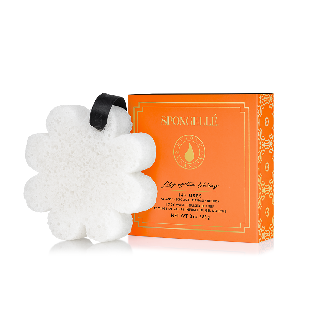 White, flower-shaped bath sponge with black loop; available in assorted scents and sizes.