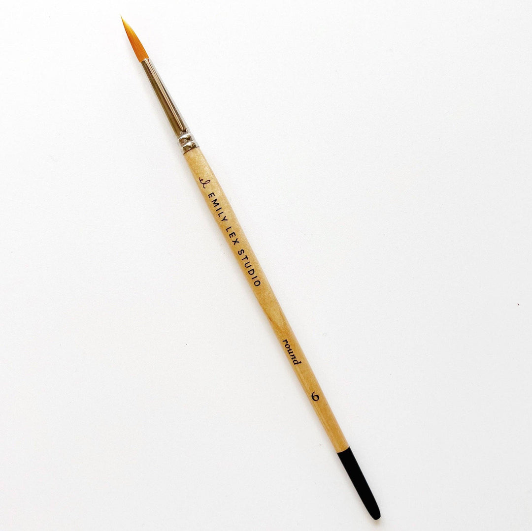 Watercolor Paintbrush, Size 0; synthetic taklon bristles, wooden handle with "EMILY LEX STUDIO" label, black tip.