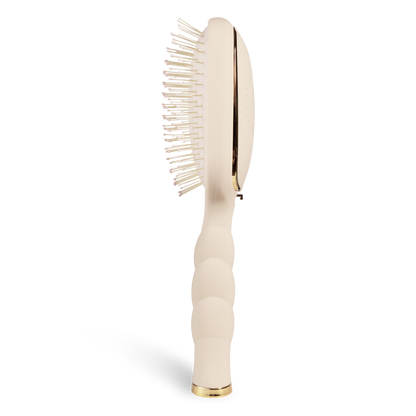 Detangler Hair Brush for Medium Hair - Tan; side view shows a curved beige handle with texture, white bristles with bead tips, gold accents; available in medium size.