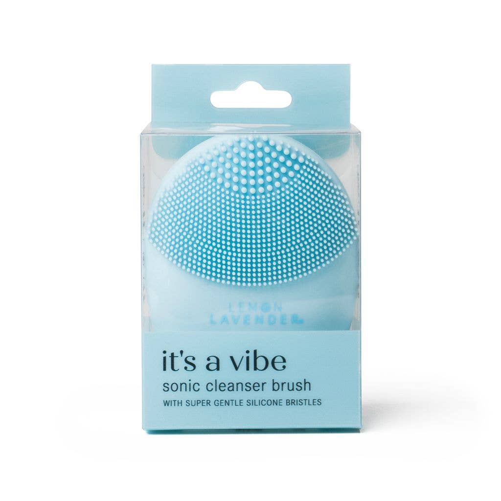 Light blue silicone sonic cleanser brush in clear box. Antibacterial. Available in standard size. For gentle exfoliation.