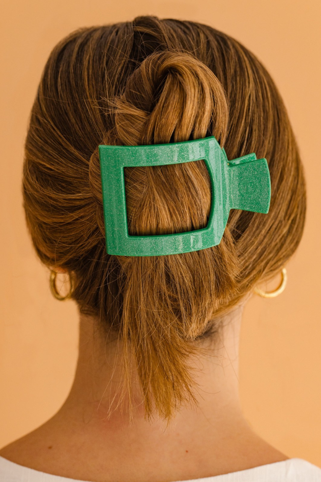 The TELETIES Square Flat Hair Clip is green and designed to secure hair in a twist. Sizes available: small, large.