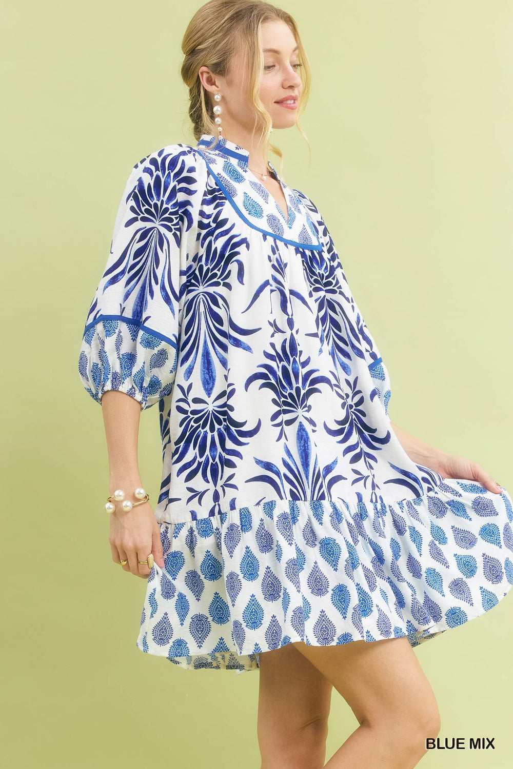 Marina Blue Mix Babydoll Dress in a loose, knee-length fit with blue mixed print and white floral and leaf patterns; available in sizes XS-XL.