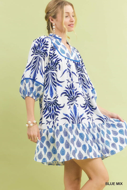 Marina Blue Mix Babydoll Dress in a loose, knee-length fit with blue mixed print and white floral and leaf patterns; available in sizes XS-XL.