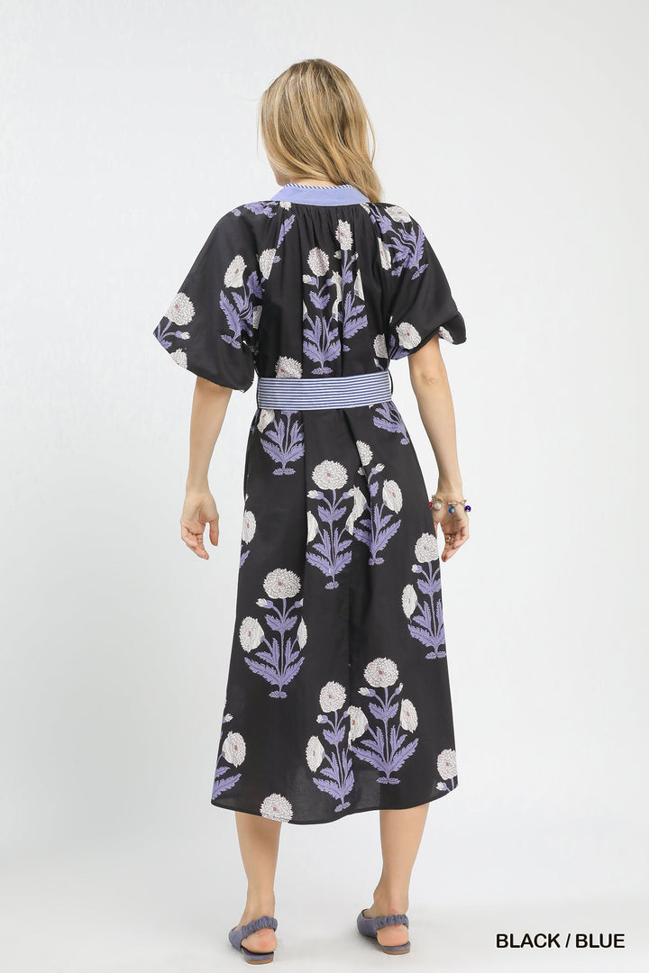 Carol Floral Print Midi Dress in black with blue and white floral pattern, blue waistband. Sizes: XS–XL.