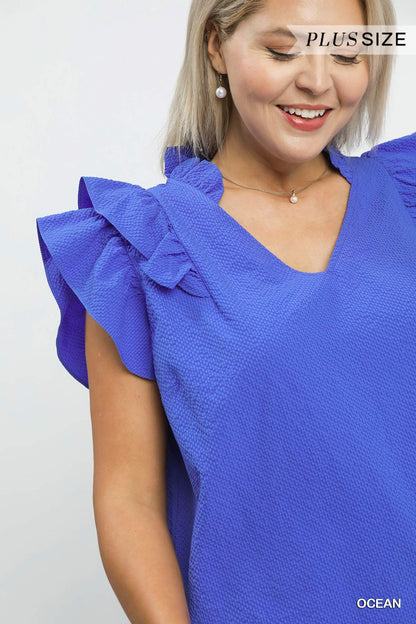 Mila Textured Ruffle Blouse in vibrant blue with ruffle sleeves, available in plus sizes.