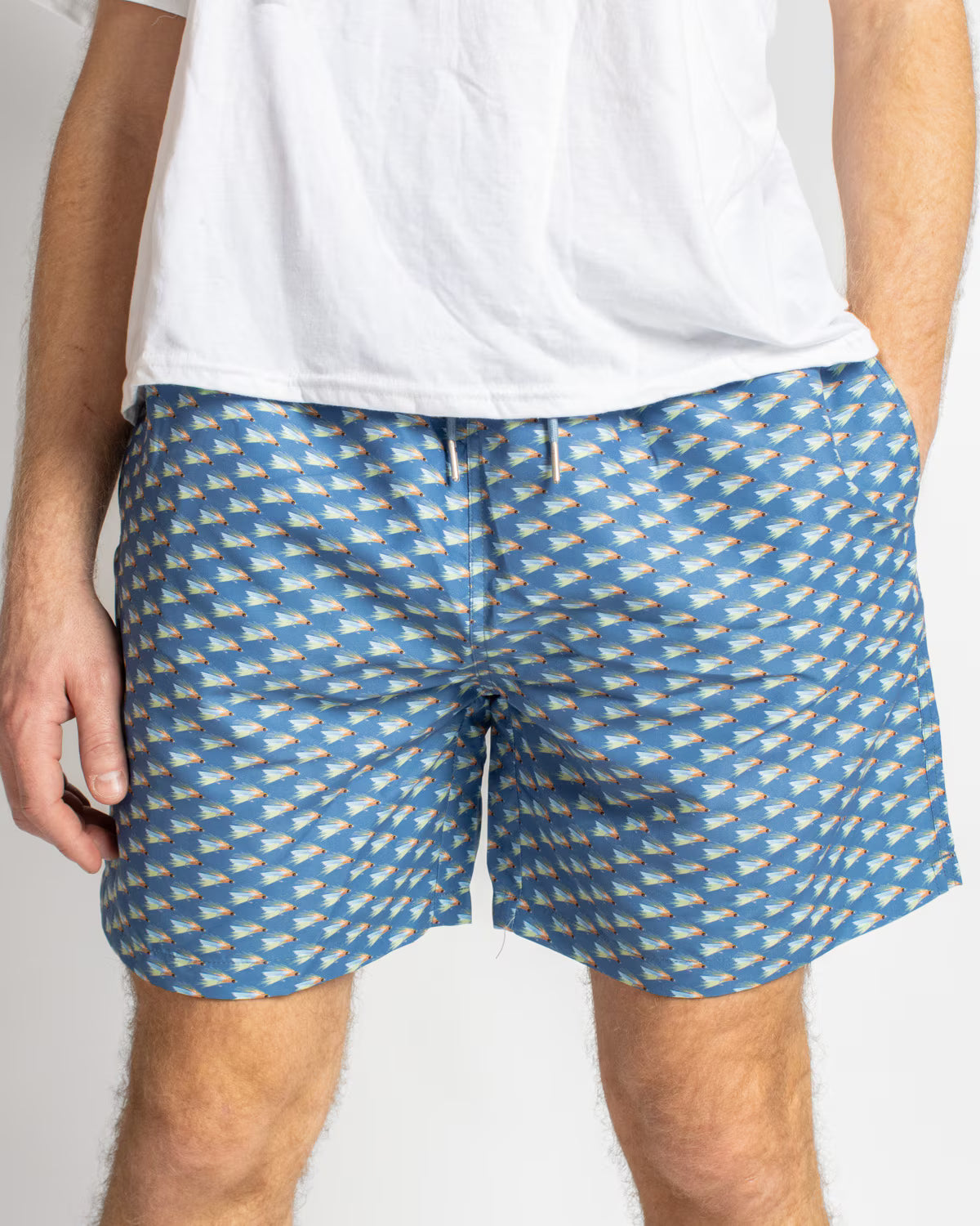 Men’s On The Fly Swim Trunks in blue with small colorful surfboards print. Available sizes: S, M, L, XL.