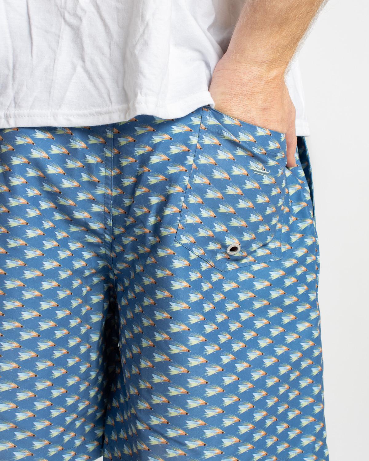Men’s On The Fly Swim Trunks in blue with sailboat pattern. Available sizes: S-XXL.