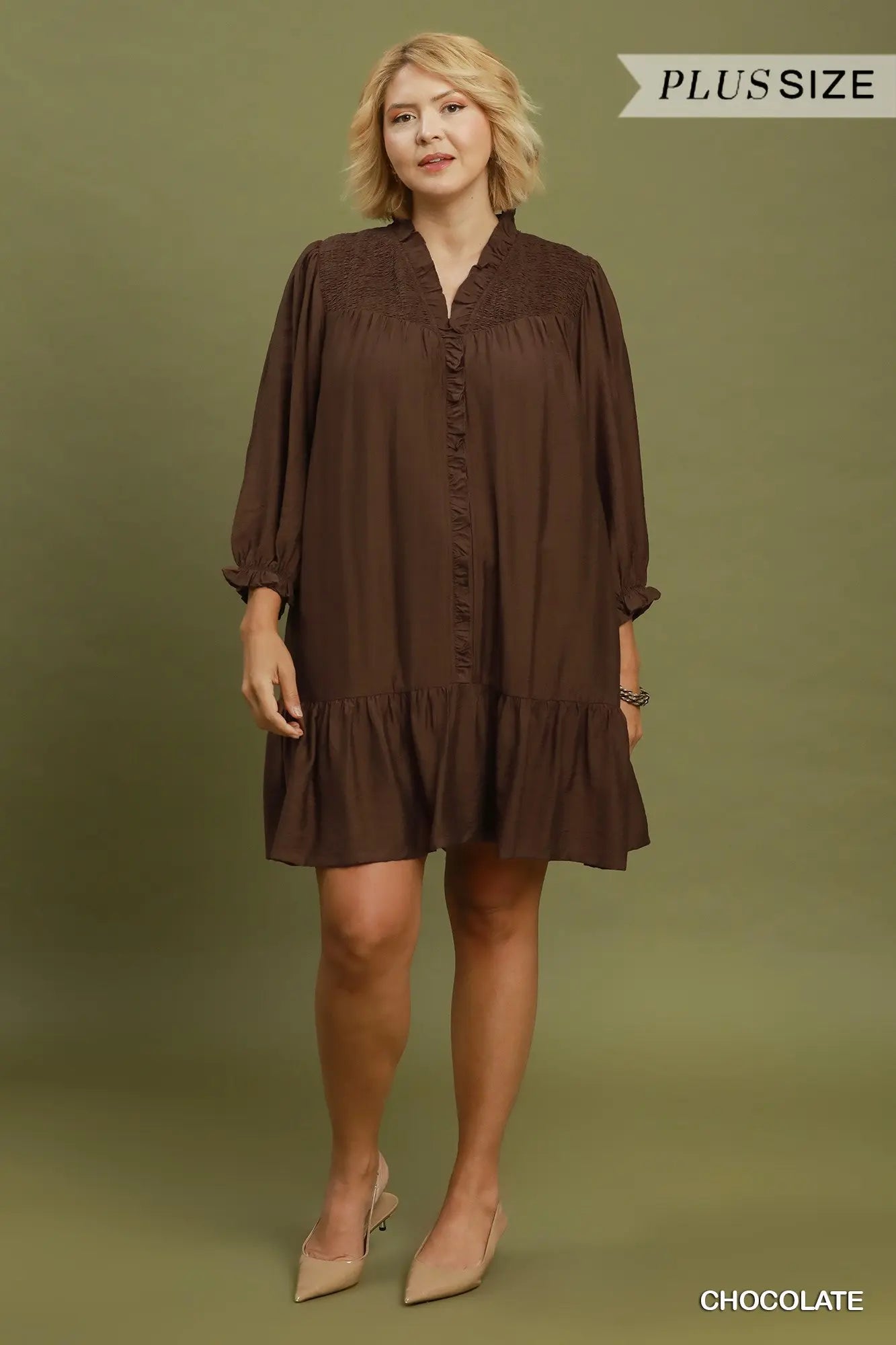 Smocked Ruffle Tiered Mini Dress in chocolate brown with a loose, flowy silhouette, long sleeves, and ruffled details. Available in sizes XS–XL.
