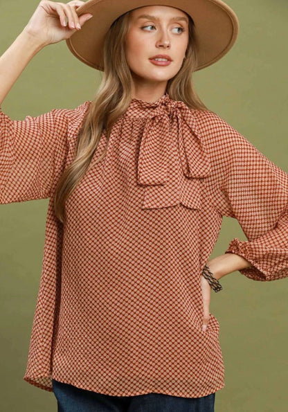 Dottie Tie Top: patterned, long-sleeve blouse with bow at neck; available in sizes XS–XL.