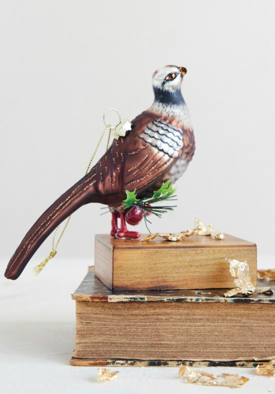Handcrafted glass pheasant ornament with brown plumage and red legs. Available in various sizes.