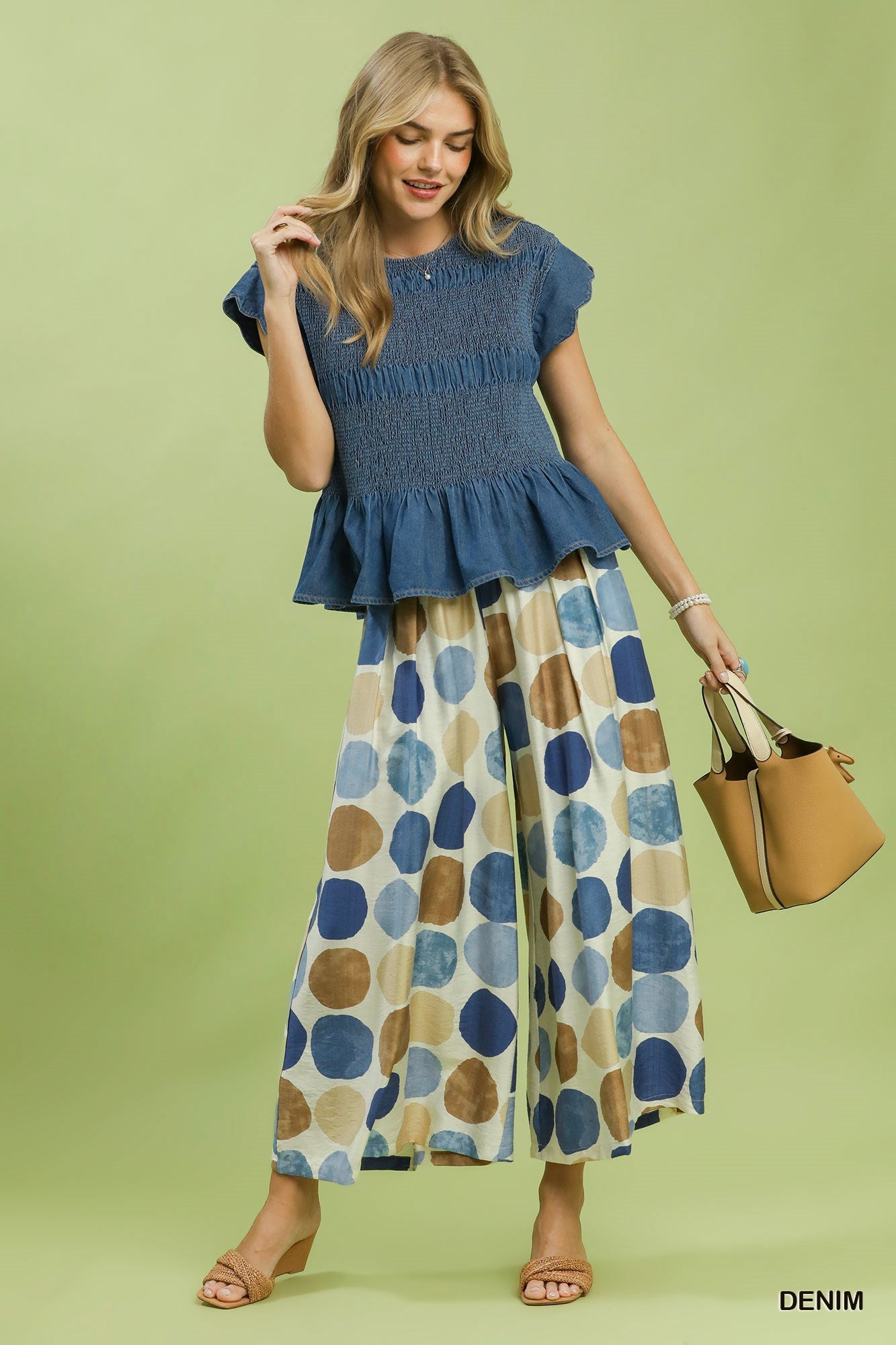 Blaire Chambray Smocked Peplum Top with a ruffled hem, available in sizes XS-XL.
