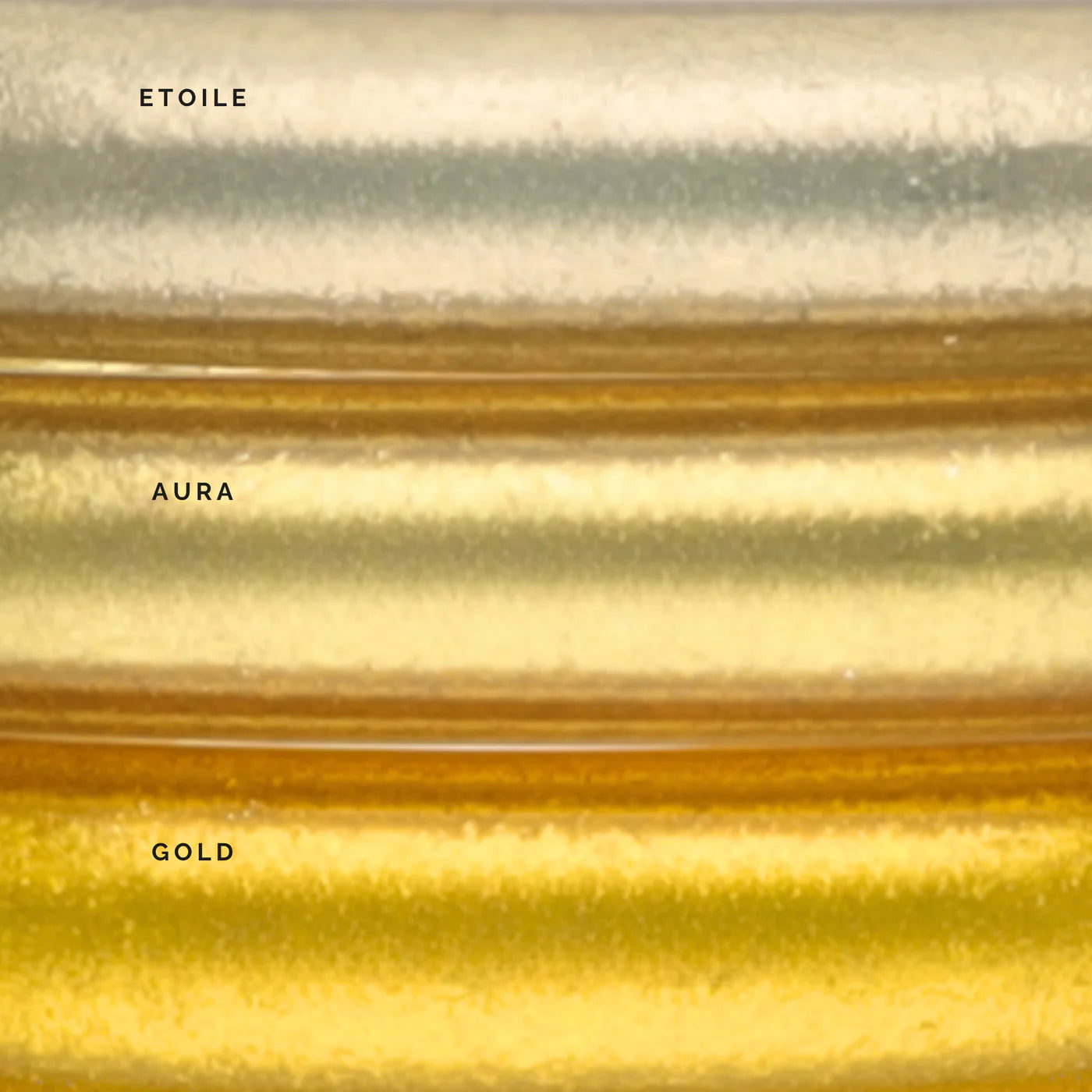 Three horizontal bands labeled Etoile, Aura, and Gold display metallic gold shades with a shimmering, textured finish for the handcrafted Aura Lumine All Weather Bangles, available in Large.