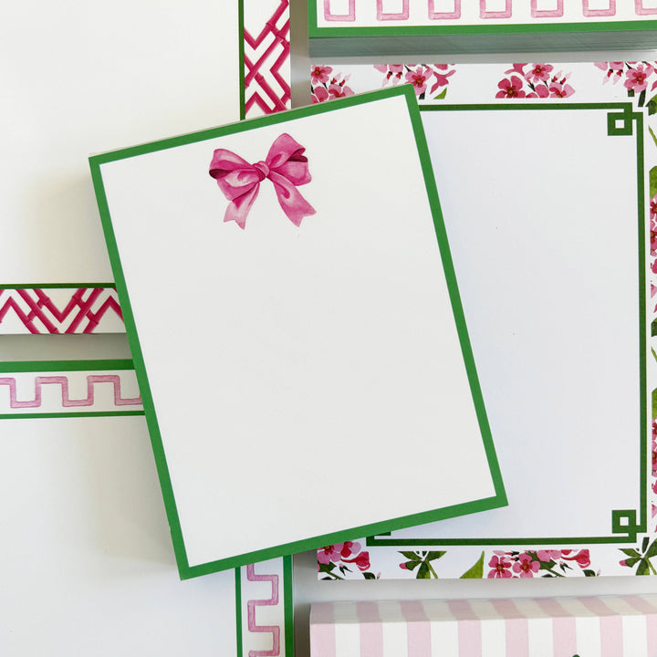 4.25 x 5.5 Pink Bow Notepad with green border, pink/green floral and geometric accents. Only available in this size.